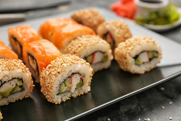 Tasty sushi rolls on plate, closeup