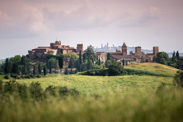 Fototapeta na wymiar Scenic panorama of medieval village of Certaldo old town, Italy, with San Gimignano towers in the background, typical Italian and Tuscany countryside landscape