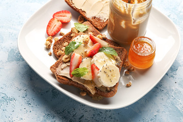 Plate with sweet toasts on table, closeup