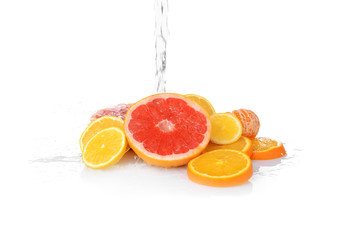 Fresh citrus fruits with splashing water on white background