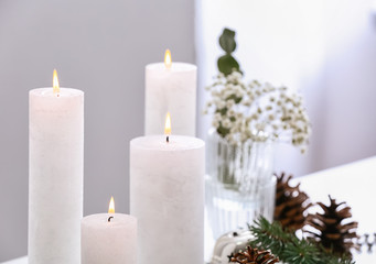 Obraz na płótnie Canvas Beautiful burning candles with Christmas decor on table