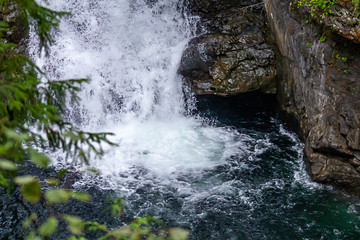 clear white water of falls hitting deep rich blue of pools below