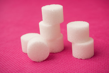  closeup of sugar in shaped circle on pink background