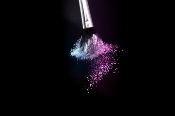 purple and blue ocean powder color splash and brush for makeup artist or graphic design in black background, look like a lively and joyful mood.