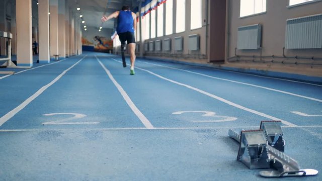 Start of running exercise of a man with a robotic leg