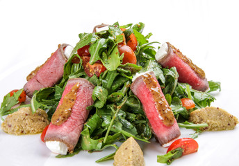 Meat rolls with cheese and salad on white background