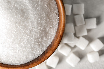 Bowl with sugar and cubes on light table
