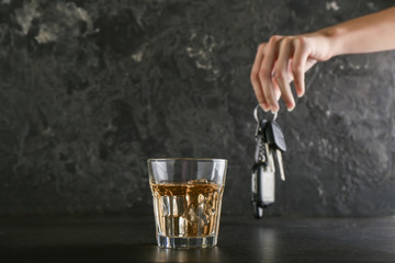 Glass of whiskey on dark background. Don't drink and drive