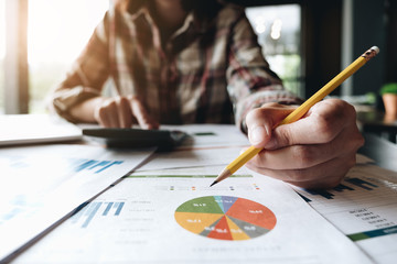 Close up of bookkeeper or financial inspector hands making report, calculating or checking balance. Home finances, investment, economy, saving money or insurance concept