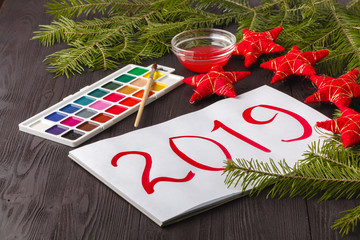 Kid christmas greeting. Drawing 2019 year symbol on paper