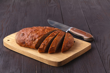 freshly baked bread on wooden cutting board isolated on white background