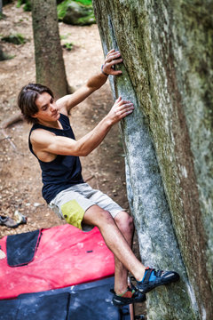 Young boy bouldering outdoor muscles