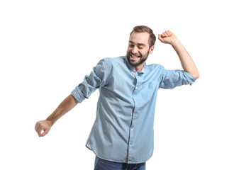 Handsome young man dancing on white background
