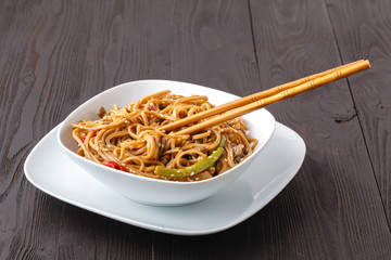 Asian noodles Yakisoba with beef and oyster mushrooms in bowl