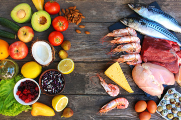     Healthy food of animal and vegetable origin on old wooden background. Concept of proper nutrition. Top view. Flat lay. - obrazy, fototapety, plakaty