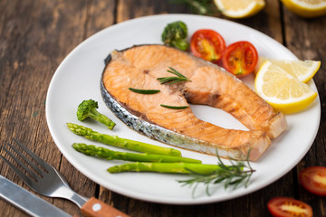 Salmon Grilled on a white plate on wooden table