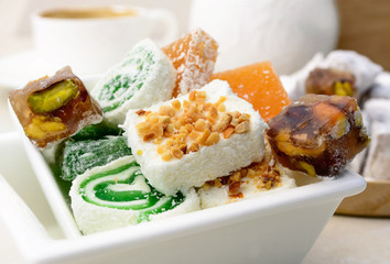 A white plate with traditional turkish delight. Close up of turkish traditional sweets.