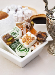 A white plate with traditional turkish delight. Close up of turkish traditional sweets.
