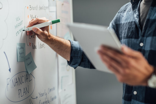 Businessman Writing On White Board