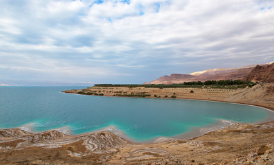 Obraz premium Landscape of the Dead Sea,Jordan, beautiful coast failures of the soil and the strong shallowing of the sea,illustrating an environmental catastrophe on the Dead Sea, Jordan. Beautiful Dead Sea coast 