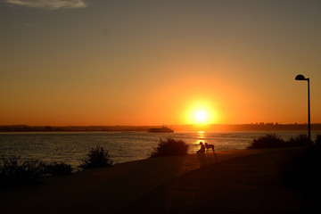 sunset overlooking the bay and boats, barreiro, lisbon