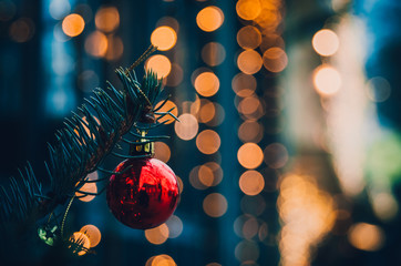 RRed ball on the pine cold tones. Christmas and new year decoration on the street closeup. Yellow...