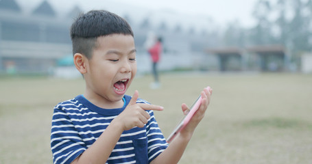  Little boy watching on smart phone