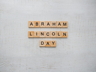 Abraham Lincoln's Birthday. Beautiful greeting card. White isolated background, close-up, top view,...