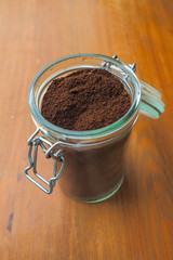 A jar with coffee on an old table