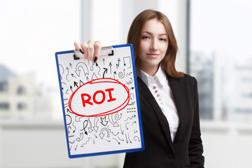 Business, technology, internet and networking concept. Young entrepreneur showing keyword: ROI