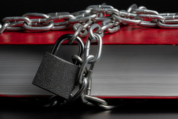 book red on a black background wrapped around the book chain on the chain