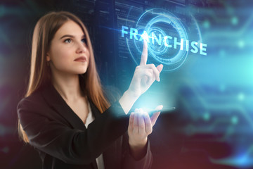 The concept of business, technology, the Internet and the network. A young entrepreneur working on a virtual screen of the future and sees the inscription: Franchise