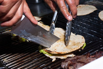 Corn tortilla roasted in charcoal accompanied by sausages and meat with sauces Guatemalan dish, fast street food, called MIXTA.