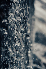 Water falling from a waterfall, macro, dark background