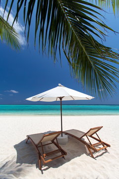 Lounge chairs on tropical beach ,Maldives