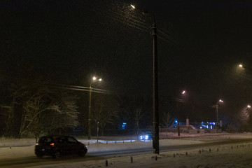 Street in the snow at night.