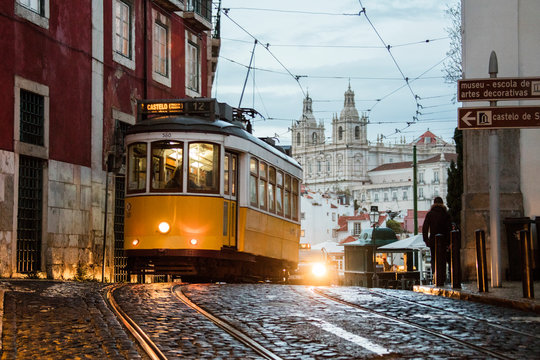 Romantic atmosphere in the old streets of  Alfama with the castle in the background and tram number 28 Lisbon Portugal Europe