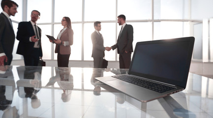 businessmen shaking hands in front of glass windows