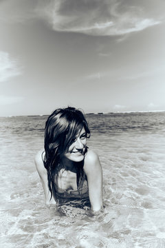 Slim woman enjoying on a sandy tropical beach.