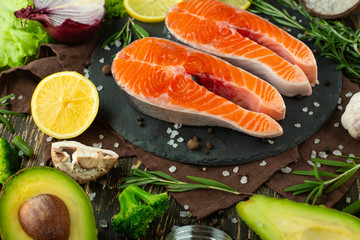 Fresh fish steak trout, salmon, salmon, red fish meat. With ingredients and vegetables on a wooden background, Flat-lay, Clean and healthy food.vegetarian