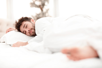 closeup.the tired men sleep soundly on the bed