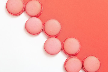 Flat lay of sweet macaroon cookies on paper background with copy space. View from above.