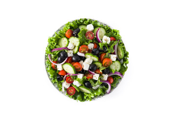 Fresh Greek salad in Plate with black olive,tomato,feta cheese, cucumber and onion isolated on white background. Top view