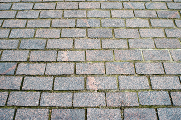 Granite pavement of the old part of the city. Background, texture