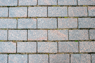 Granite pavement of the old part of the city. Background, texture
