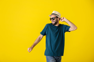 Handsome young man dancing on color background