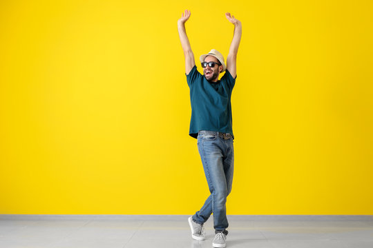 Handsome Young Man Dancing Near Color Wall