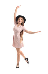 Beautiful young woman dancing on white background