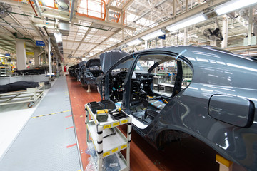 Add details to car body. Robotic equipment makes Assembly of car. Modern car Assembly at factory