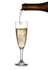 Pouring of tasty champagne into glass on white background